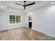 Spacious bedroom with ceiling fan, hardwood flooring, and an adjacent kitchen area at 1524 Enochville Rd, Kannapolis, NC 28081