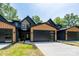Modern townhome with a black and wood exterior, black garage doors, and concrete driveway at 1524 Enochville Rd, Kannapolis, NC 28081