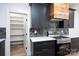 Modern kitchen boasts sleek dark cabinets, wooden range hood, and marble backsplash with stainless steel oven at 1524 Enochville Rd, Kannapolis, NC 28081