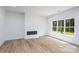 Bright living room featuring a modern fireplace and a large window with natural light at 1524 Enochville Rd, Kannapolis, NC 28081