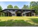 Backyard of property with green lawn, shaded trees and backyard patio area at 1528 Enochville Rd, Kannapolis, NC 28081