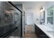 Modern bathroom featuring a walk-in shower, sleek black fixtures, and a dual sink vanity with quartz countertops at 1528 Enochville Rd, Kannapolis, NC 28081
