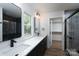 Modern bathroom features dual sinks, quartz countertops, sleek black fixtures, and a glass-enclosed shower at 1528 Enochville Rd, Kannapolis, NC 28081