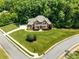 Expansive aerial view of a stately brick home surrounded by mature trees and a well-maintained yard at 1600 Buckland Ct, Indian Land, SC 29707