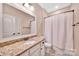 This bathroom boasts a granite vanity, white cabinets, and tile floors at 1600 Buckland Ct, Indian Land, SC 29707