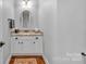 Half bathroom with a granite countertop, white cabinetry, and neutral walls at 1600 Buckland Ct, Indian Land, SC 29707