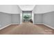 Spacious carpeted room with large windows, neutral walls, and room for a desk at 1600 Buckland Ct, Indian Land, SC 29707