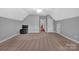 This carpeted bonus room offers flexible space, natural light and a black chair at 1600 Buckland Ct, Indian Land, SC 29707
