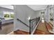 Upstairs hallway with wood floors and banister with bedrooms on either side at 1600 Buckland Ct, Indian Land, SC 29707