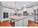 Open kitchen featuring granite countertops, modern appliances, white cabinetry, and a large island at 1600 Buckland Ct, Indian Land, SC 29707