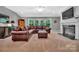Comfortable living room featuring a fireplace, a large leather couch, and natural light at 1600 Buckland Ct, Indian Land, SC 29707