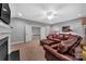 Another view of the living room with leather couch, fireplace, and doorway at 1600 Buckland Ct, Indian Land, SC 29707
