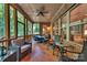 Relax on the screened porch with exposed brick, a ceiling fan and wooded views at 1600 Buckland Ct, Indian Land, SC 29707