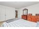This carpeted bedroom features a bed and two vintage wood dressers at 1817 Tradd Ave, Clover, SC 29710