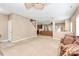Open-concept living room with neutral paint, carpet, and staircase access at 1817 Tradd Ave, Clover, SC 29710