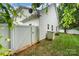 Backyard view with white fence, grassy area, and a small storage shed at 18715 Coachmans Trce, Cornelius, NC 28031