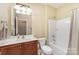 Standard bathroom with vanity, toilet, and shower-tub combo with curtain at 18715 Coachmans Trce, Cornelius, NC 28031