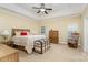 Comfortable bedroom featuring tray ceiling, neutral decor, and traditional furniture at 18715 Coachmans Trce, Cornelius, NC 28031