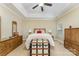 Comfortable bedroom featuring tray ceiling, neutral decor, and traditional furniture at 18715 Coachmans Trce, Cornelius, NC 28031