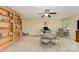 Inviting bonus room with built-in shelving, versatile seating, and ample space for relaxation at 18715 Coachmans Trce, Cornelius, NC 28031