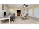Versatile bonus room featuring a ceiling fan, bright natural light, and a puzzle table at 18715 Coachmans Trce, Cornelius, NC 28031