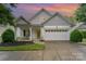 Charming two-story home featuring well-manicured landscaping and an attached two-car garage at 18715 Coachmans Trce, Cornelius, NC 28031