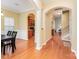 Spacious hallway featuring hardwood floors, arched doorways, and ample natural light at 18715 Coachmans Trce, Cornelius, NC 28031