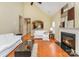 Open living room featuring hardwood floors, fireplace, vaulted ceiling, and seamless flow to the kitchen at 18715 Coachmans Trce, Cornelius, NC 28031