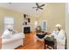Bright living room with a fireplace, hardwood floors, high ceilings, and a ceiling fan at 18715 Coachmans Trce, Cornelius, NC 28031