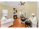 Bright living room with a fireplace, hardwood floors, high ceilings, and a ceiling fan at 18715 Coachmans Trce, Cornelius, NC 28031