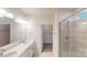 Bathroom featuring double sinks, quartz countertops, a glass-enclosed shower and a walk-in closet at 2070 Skyhawk Dr, York, SC 29745