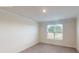 Bright bedroom with neutral carpeting, white walls, and a large window overlooking the property at 2070 Skyhawk Dr, York, SC 29745