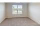 Carpeted bedroom with a window providing views of the trees and sky at 2070 Skyhawk Dr, York, SC 29745