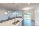 Modern kitchen featuring a large island with quartz countertops, stainless steel sink, and pendant lighting at 2070 Skyhawk Dr, York, SC 29745