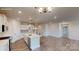 Modern kitchen and living space with white cabinets, stainless steel appliances, and an open layout at 2070 Skyhawk Dr, York, SC 29745