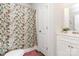 Cozy bathroom with a floral shower curtain, white vanity, and coordinated decor creating a fresh, clean aesthetic at 218 Canina Ln, Indian Trail, NC 28079