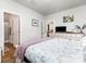 Bright bedroom featuring a cozy bed with a view of the ensuite bathroom and open kitchen at 218 Canina Ln, Indian Trail, NC 28079