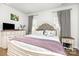 Bright bedroom featuring a cozy bed with a tufted headboard, and neutral walls at 218 Canina Ln, Indian Trail, NC 28079