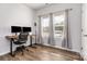 Bright bedroom with wood floors, neutral walls, filled with natural light from large windows dressed with gray curtains at 218 Canina Ln, Indian Trail, NC 28079