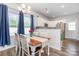 Bright dining area featuring a wood table, seating for four, modern lighting, and views of the kitchen at 218 Canina Ln, Indian Trail, NC 28079