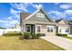 Charming exterior view of a two-story home with a well-manicured lawn and a paved driveway on a sunny day at 218 Canina Ln, Indian Trail, NC 28079