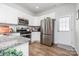 Modern kitchen featuring stainless steel appliances, granite countertops, white cabinets, and wood-look flooring at 218 Canina Ln, Indian Trail, NC 28079