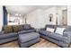 Cozy living room with plush seating, modern decor, and a seamless transition to the dining area and kitchen at 218 Canina Ln, Indian Trail, NC 28079