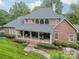 Aerial view of a brick home featuring a covered patio, manicured landscaping, and outdoor grill at 2300 Richardson Dr, Charlotte, NC 28211