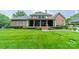 Stately brick home featuring a covered porch, landscaped yard, and mature trees at 2300 Richardson Dr, Charlotte, NC 28211