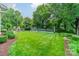 Manicured backyard with a basketball court, inviting fireplace, and professionally maintained lawn at 2300 Richardson Dr, Charlotte, NC 28211