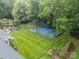 Backyard basketball court alongside stone fireplace and manicured lawn at 2300 Richardson Dr, Charlotte, NC 28211