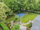 Aerial view of landscaped backyard with basketball court and stone fireplace at 2300 Richardson Dr, Charlotte, NC 28211