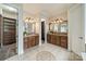 Elegant bathroom with double vanities, granite countertops, and access to walk in closets at 2300 Richardson Dr, Charlotte, NC 28211