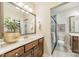 Well-lit bathroom with granite counters, a tiled shower, and vanity at 2300 Richardson Dr, Charlotte, NC 28211